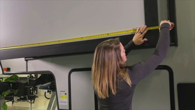 Person measuring an RV slide